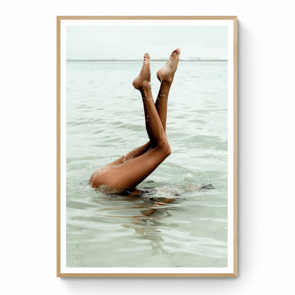 A print of a girl on a vacation in Bali, Indonesia to ducks under the crystal clear water to escape the noise of her every day life and finds solace in the silence under the water 